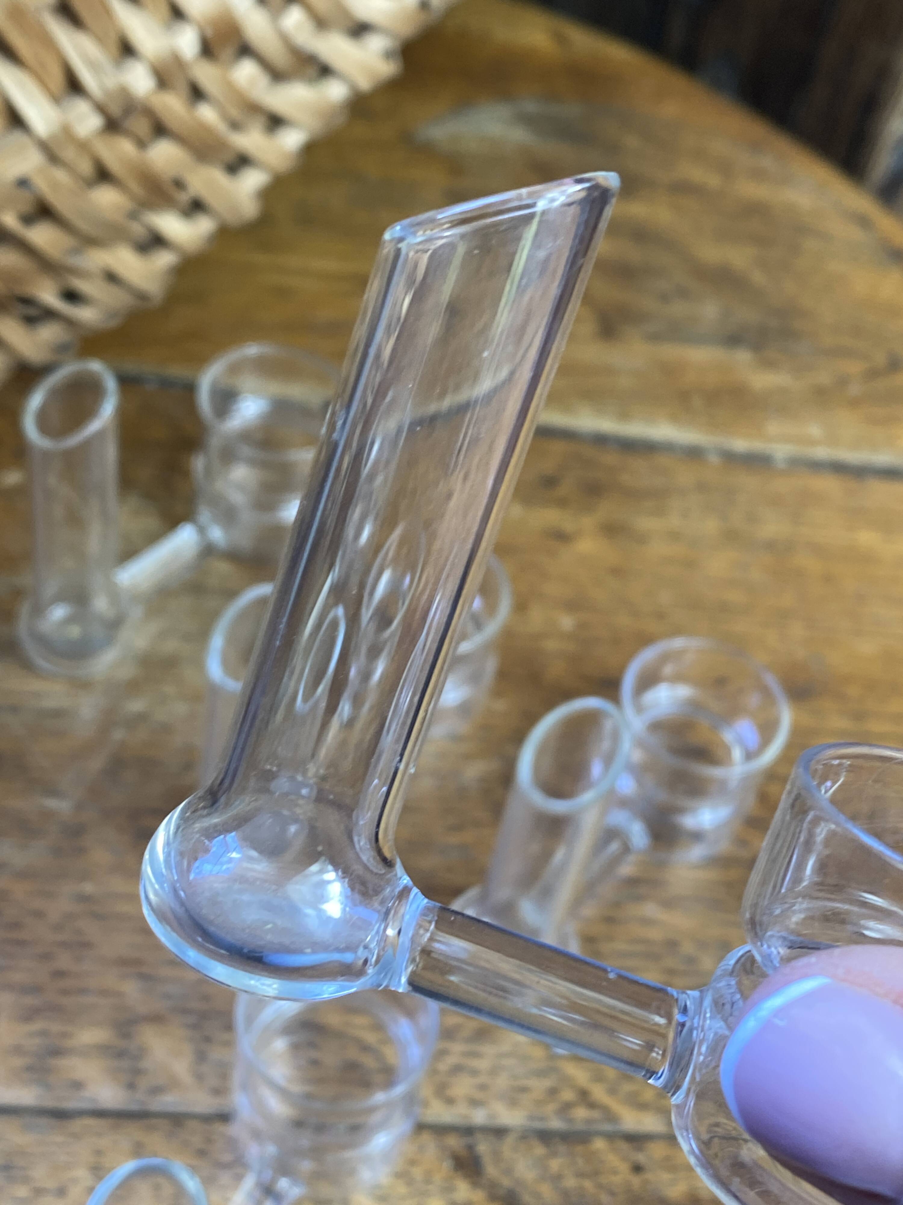 Knife rests, flower vases and candle holders in blown glass.