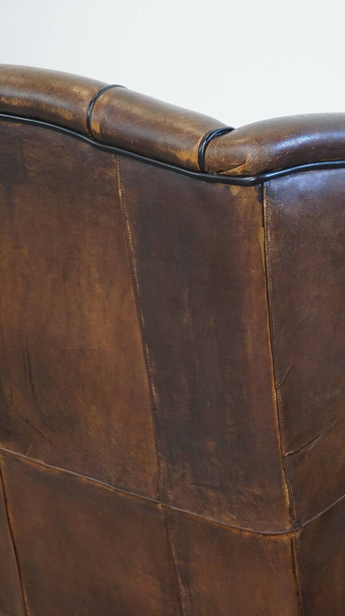 Wing chair made of sheepskin and neatly finished with black piping