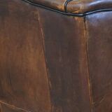 Wing chair made of sheepskin and neatly finished with black piping