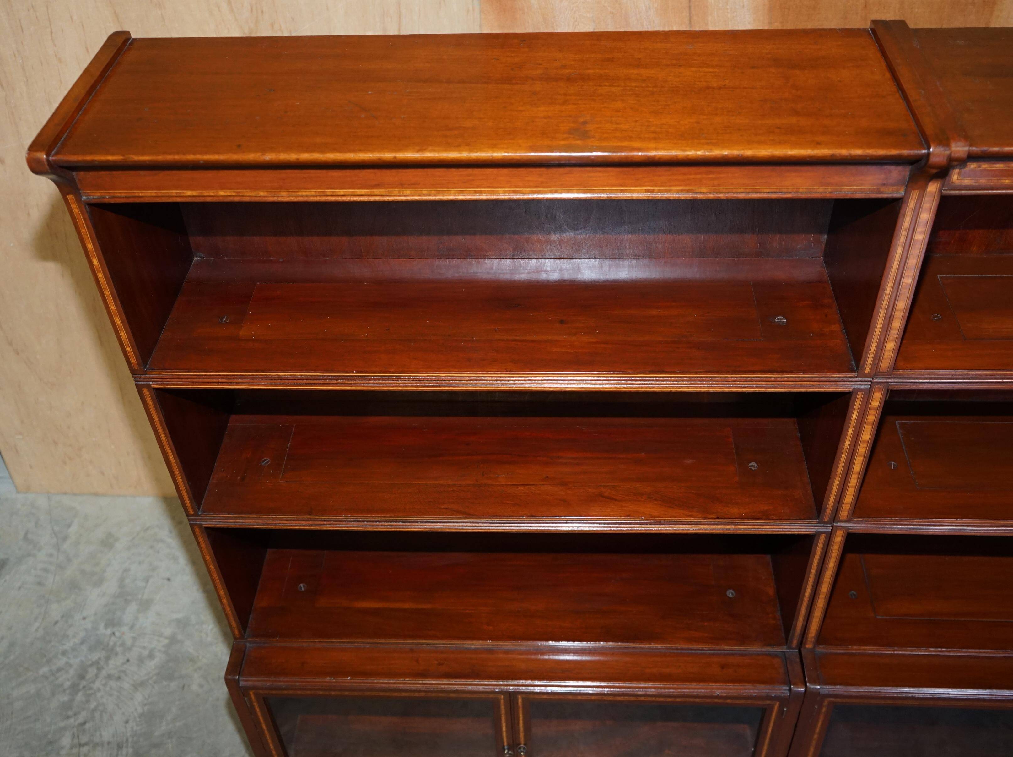 Antique pair of legal bookcases by William Baker Co in hardwood, satin and walnut.