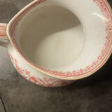 Old pitcher in red-decorated earthenware.