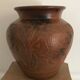 Vase or pot in brown terracotta with artistic decoration of fish.