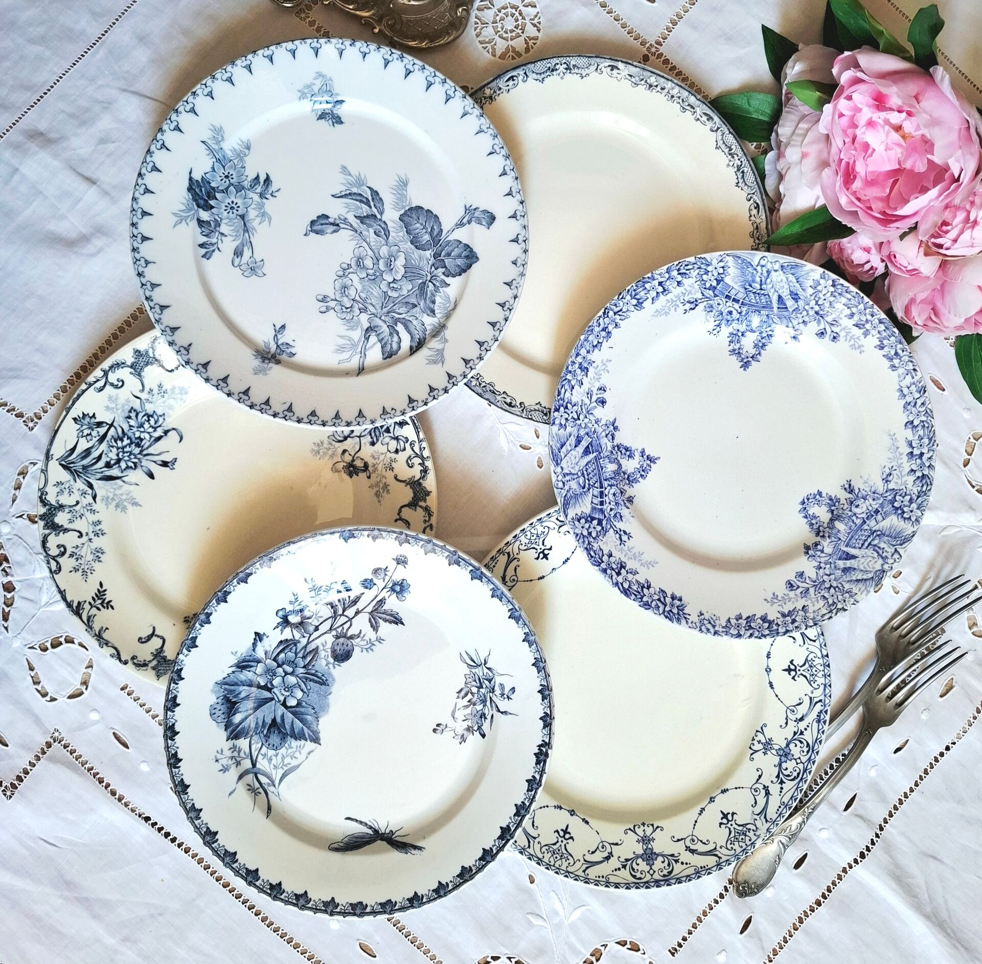 Old mismatched flat plates made of ironstone earthenware.