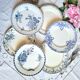 Old mismatched flat plates made of ironstone earthenware.