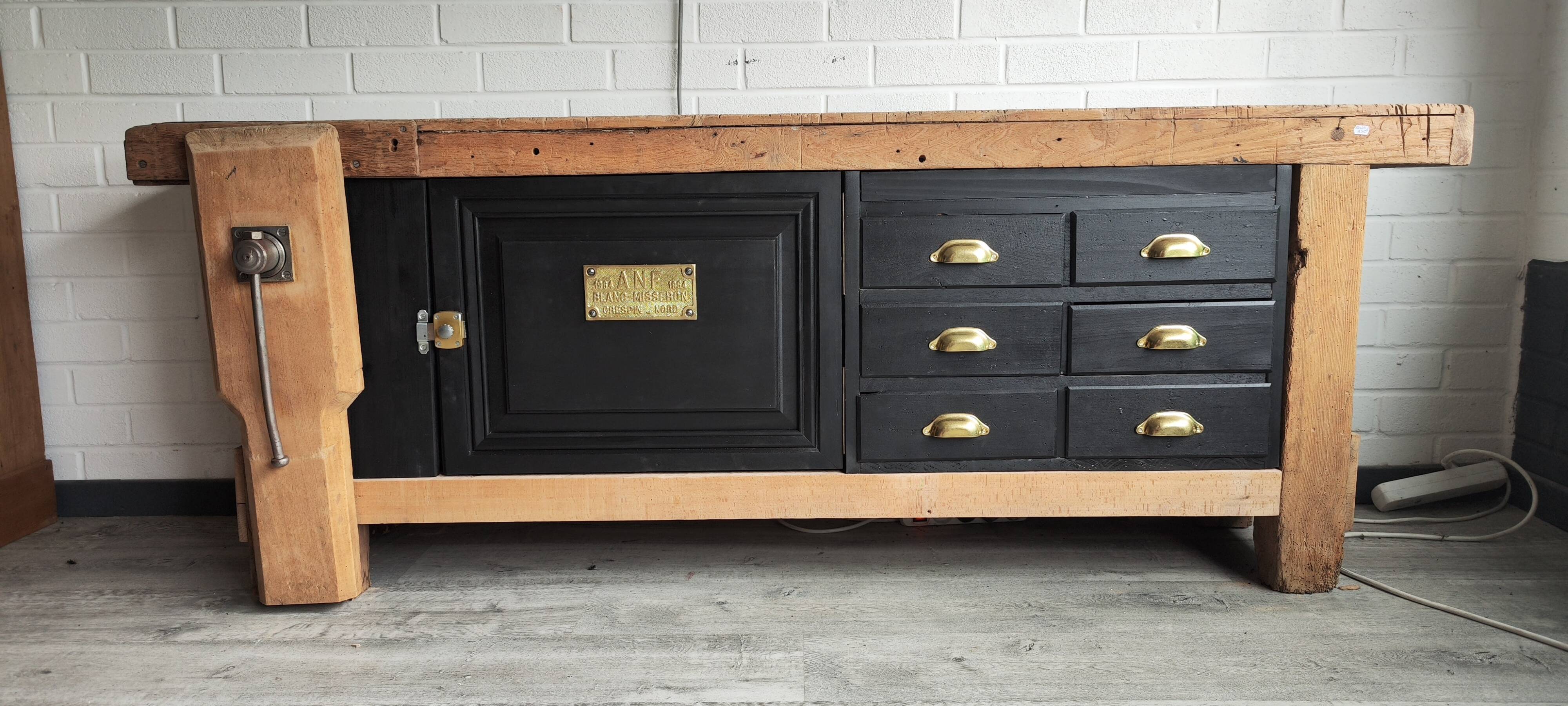 Old workbench furniture with six drawers and a door