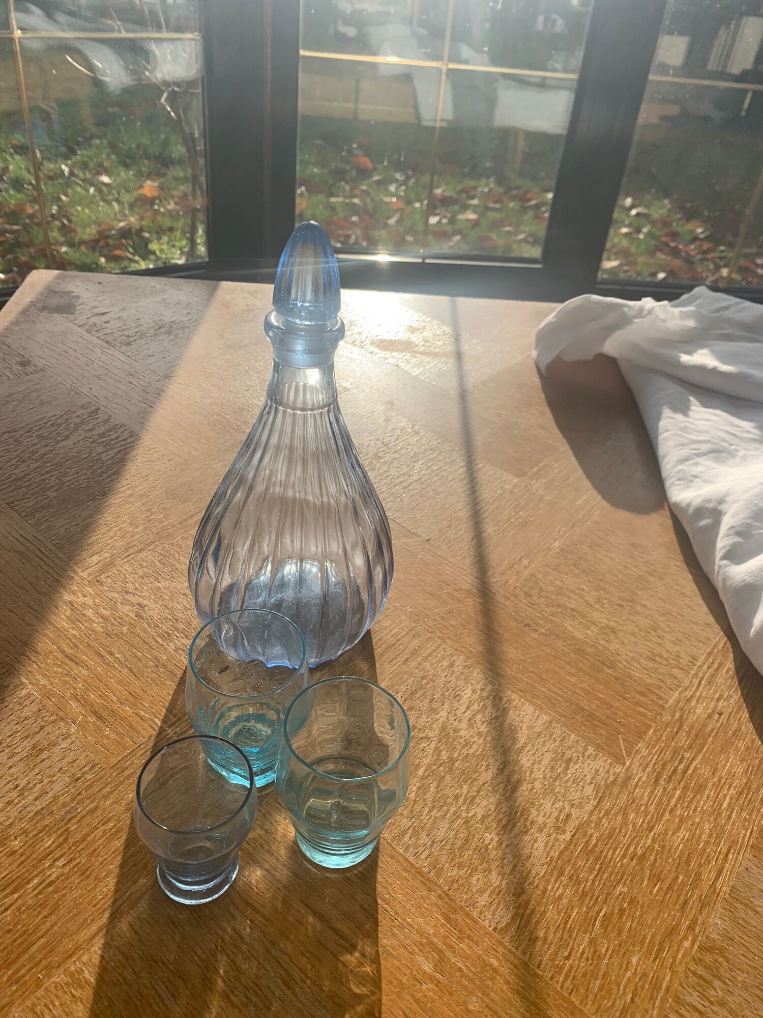 Liquor service consisting of a blue glass decanter and. 3 small antique glasses
