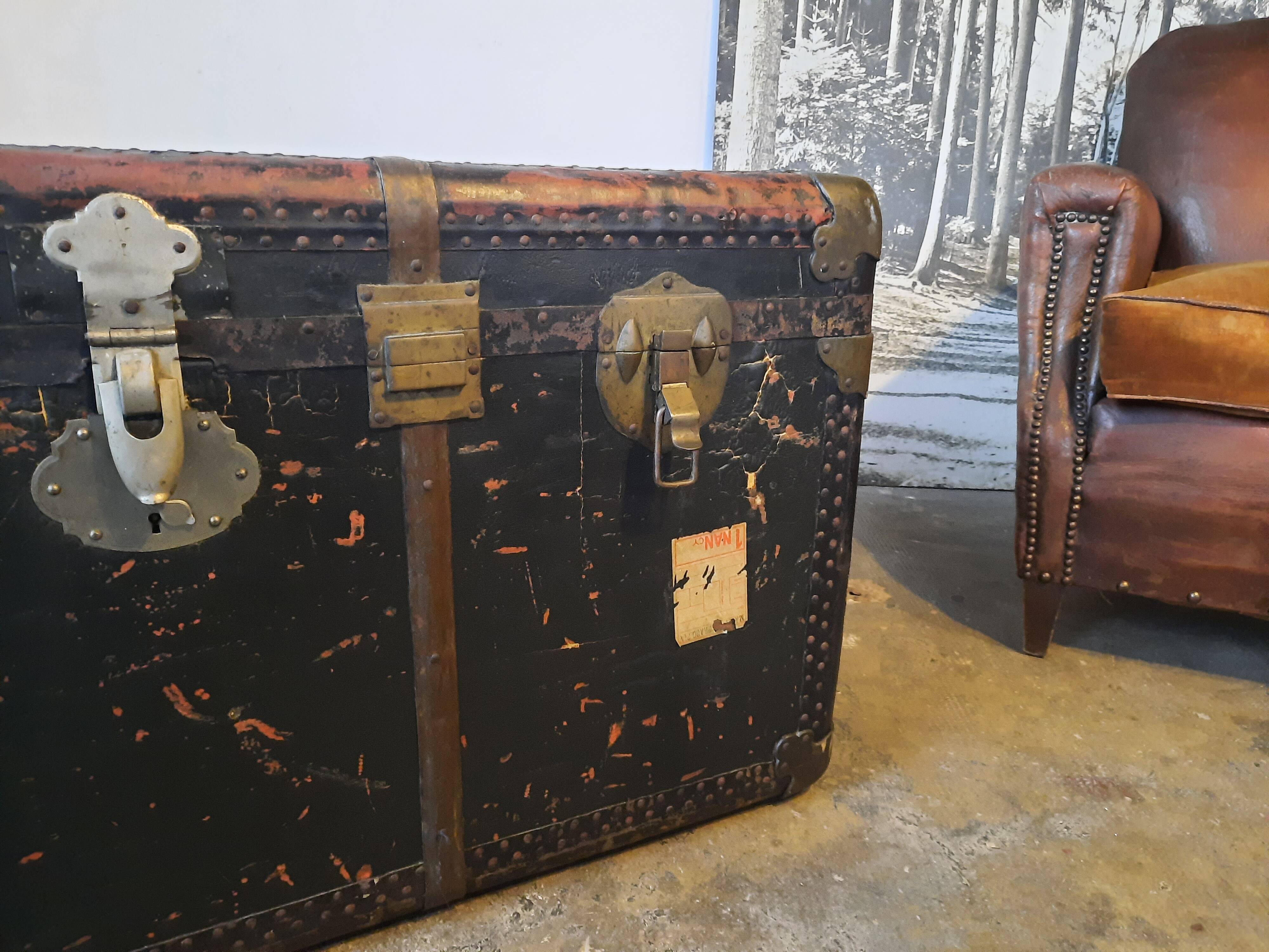 Old and large travel trunk, brass-plated corners