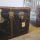 Old and large travel trunk, brass-plated corners