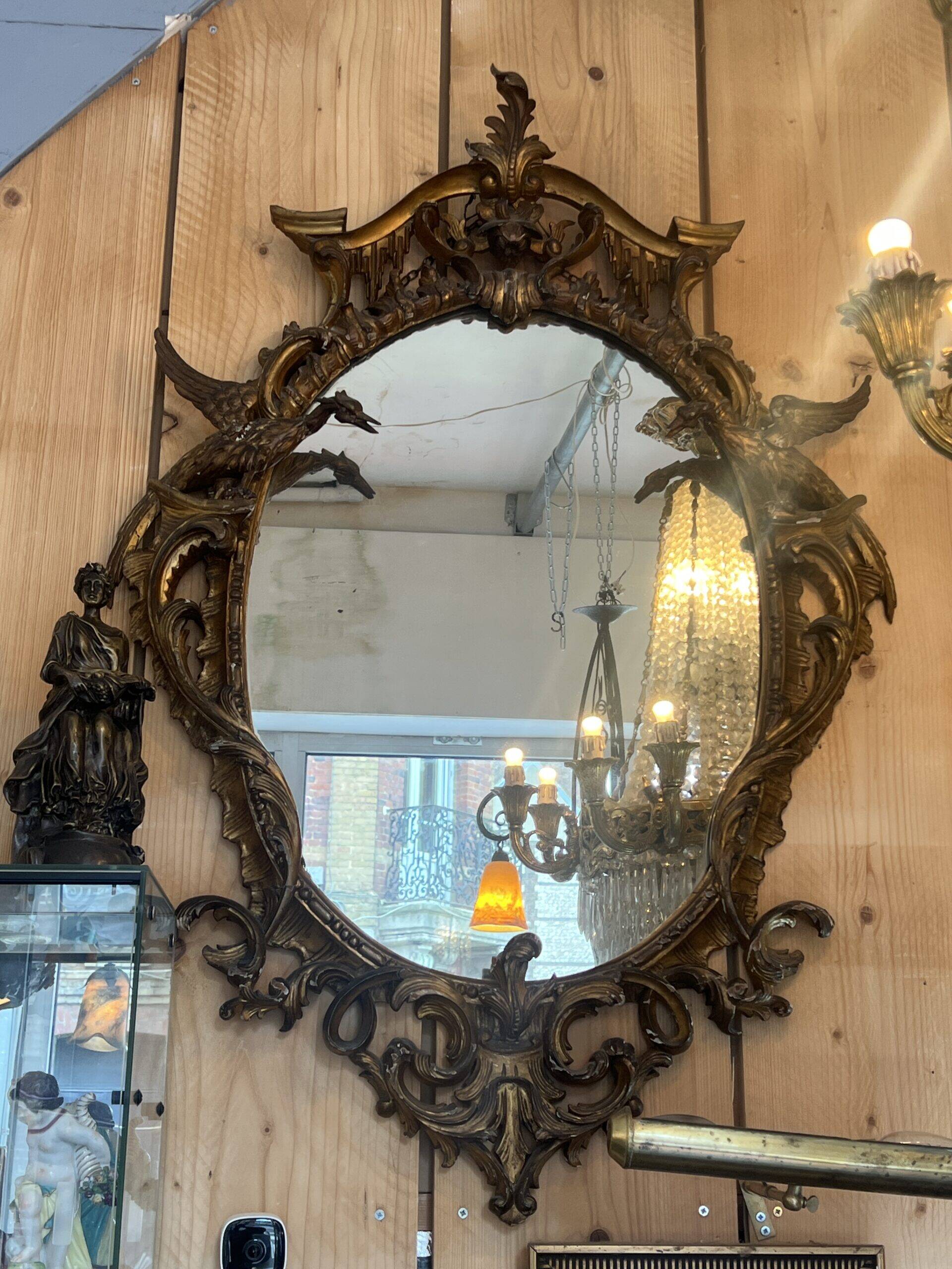 Large gilded wooden mirror, richly carved with winged dragons, 19th century