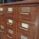 Office furniture has oak drawers 1950 brass handles and label holders