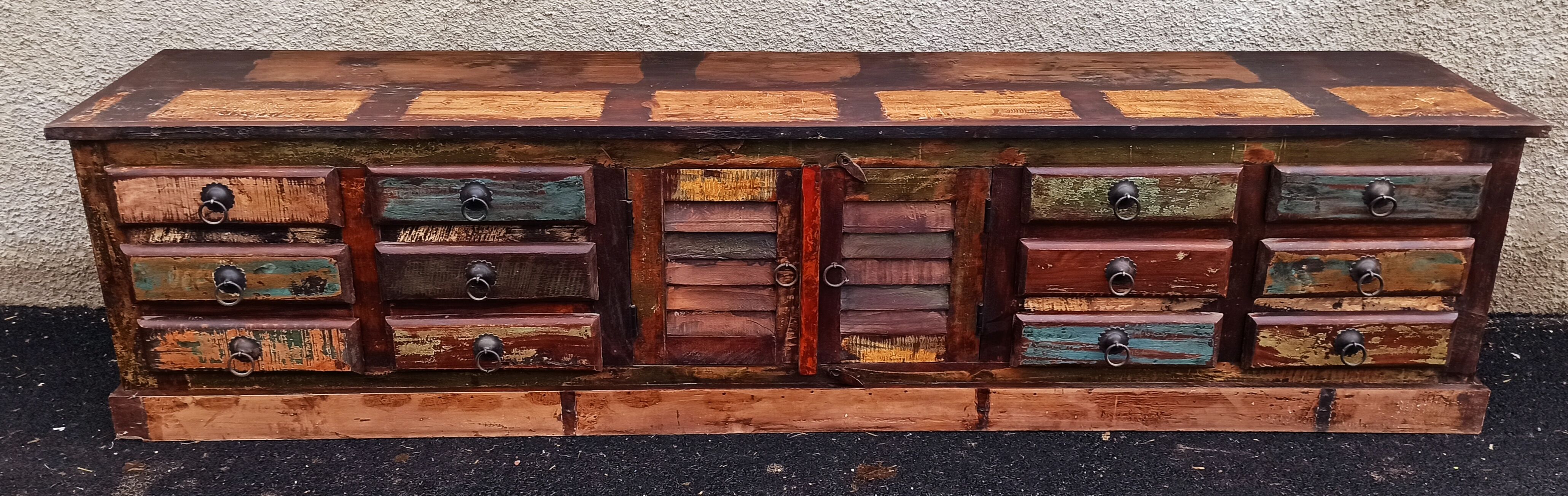 Furniture low in colorful wood. 12 drawers and 1 door