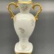 Small amphora vase in Limoges porcelain with gilded handles.