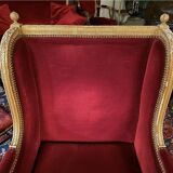 Golden wooden bergère in Louis XVI style upholstered in Bordeaux velvet.