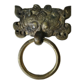 Ancient door knocker, taotié mask, shang dynasty. in bronze golden patina