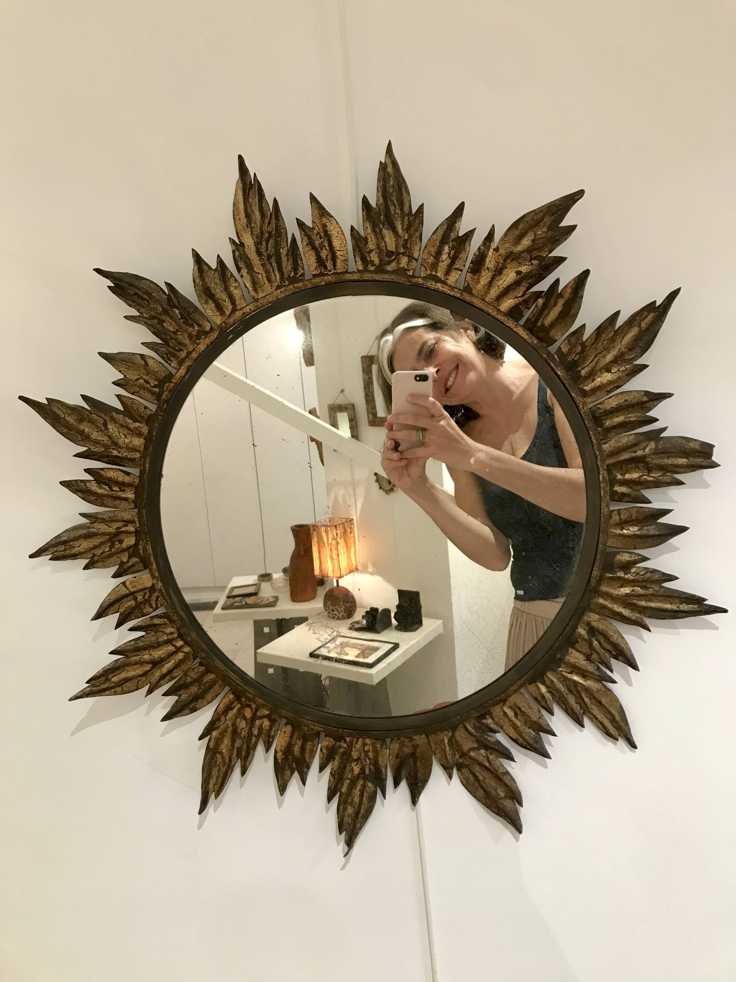 Sun mirror decorated with golden leaves, circa 1950.