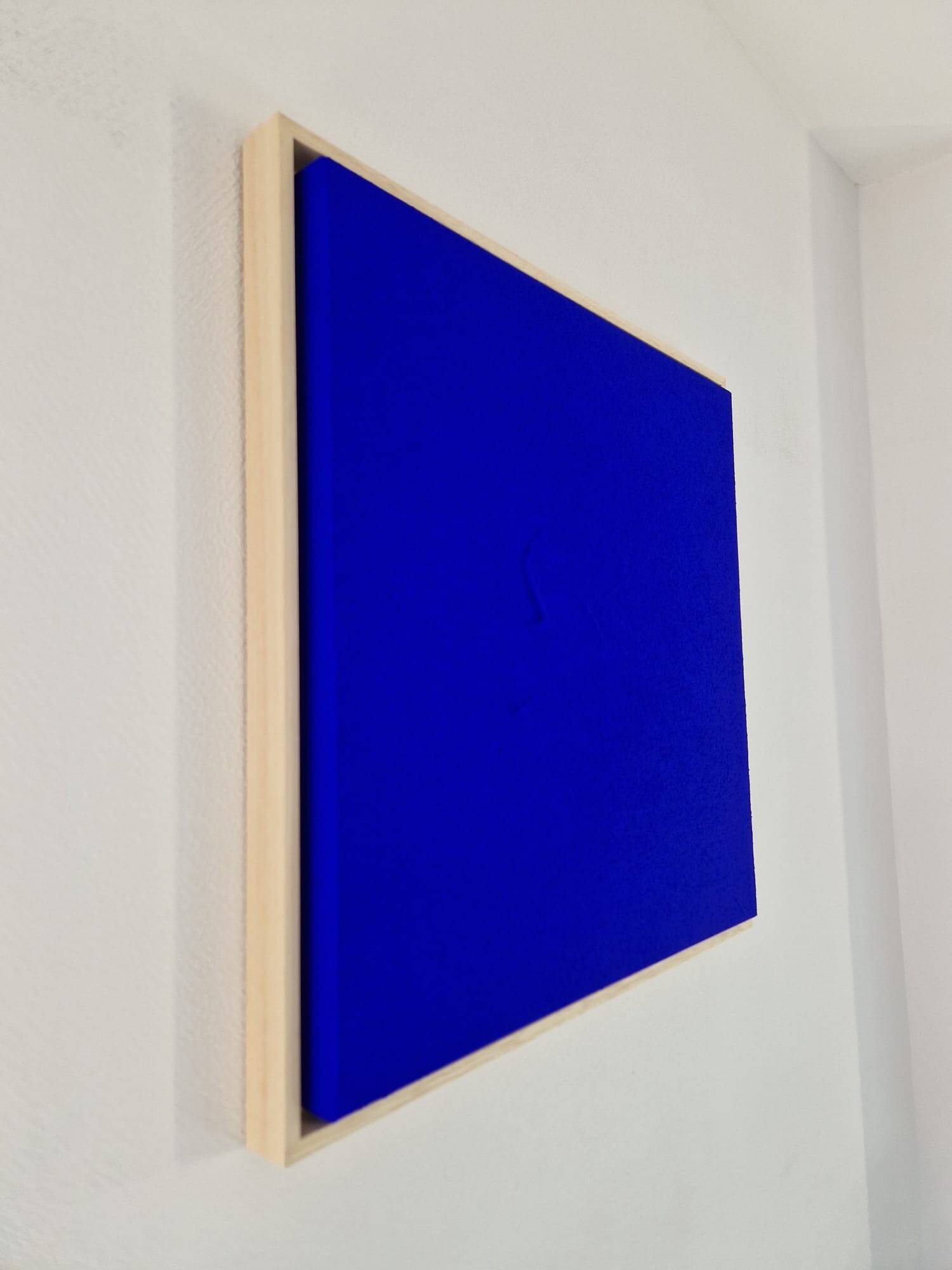 Framed monochrome blue abstract painting.