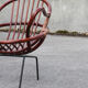 Rattan shell armchair with metal feet