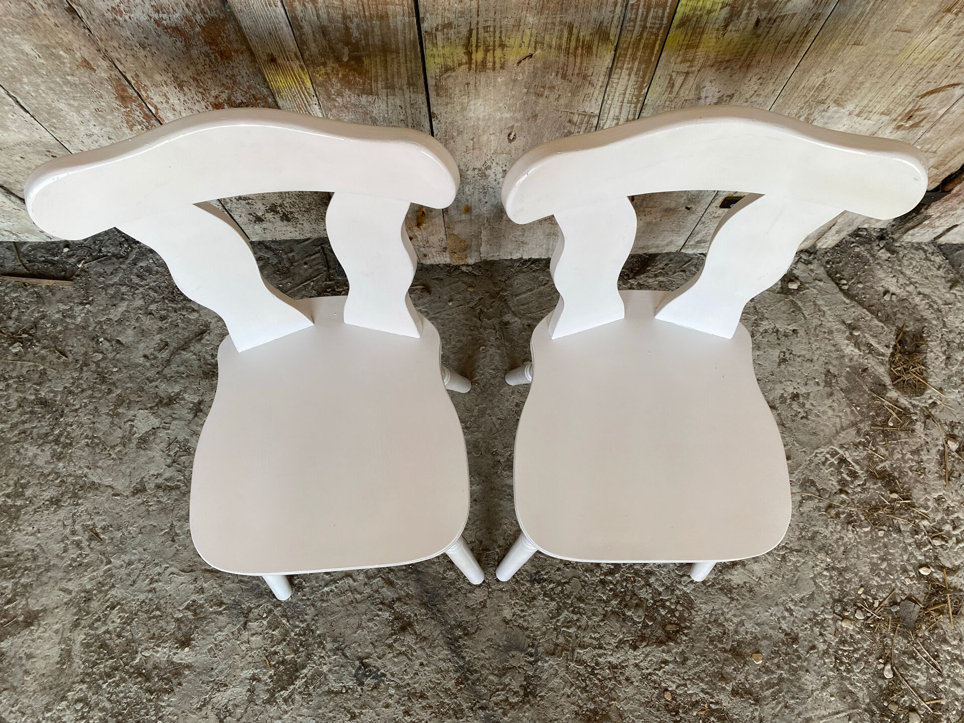 Pair of vintage white wooden bistro chairs
