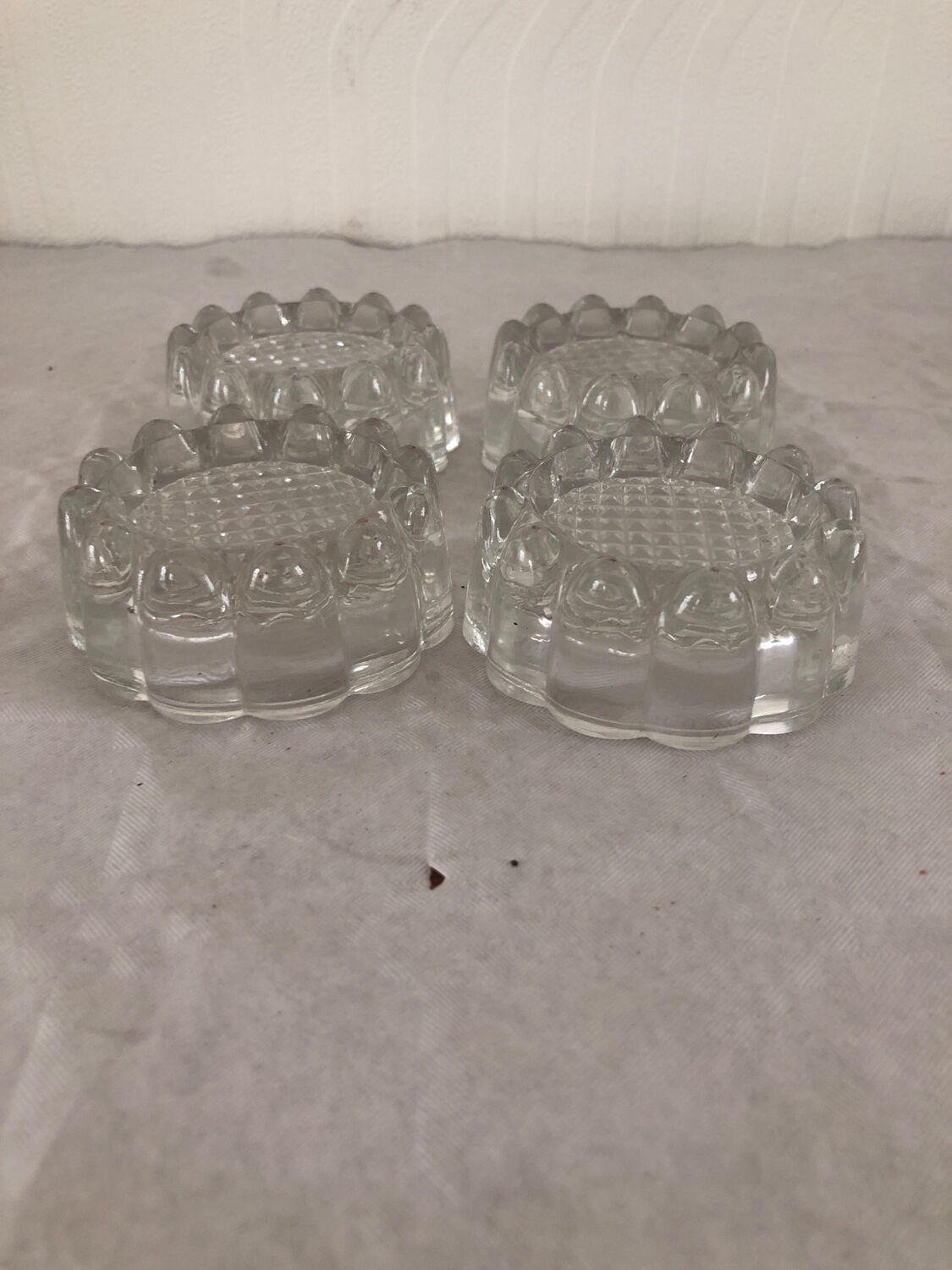 4 flat glass candle holders cut in the shape of Vintage flowers