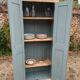 Small antique wardrobe with a faded white patina.