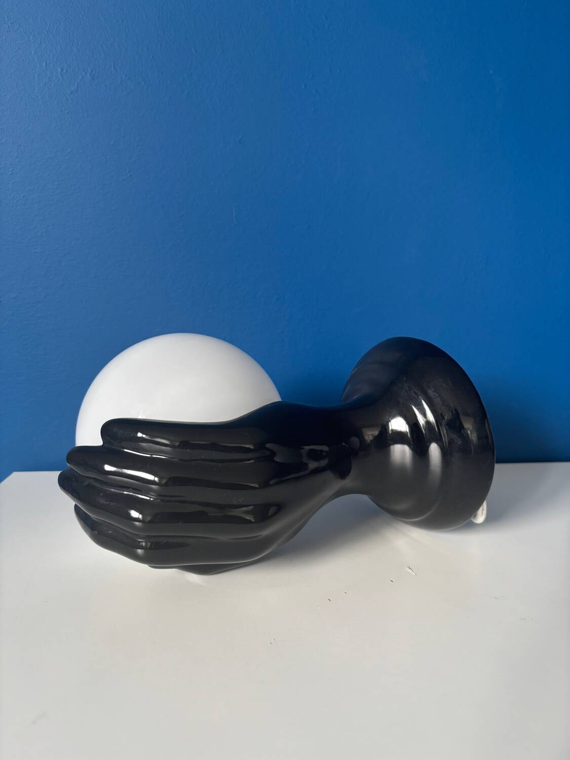 Vintage wall sconce with black hand and white opaline glass globe, 1970s L