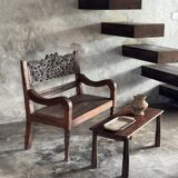 Small antique Indonesian bench in carved teak with plant and floral motifs.