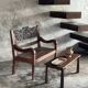 Small antique Indonesian bench in carved teak with plant and floral motifs.