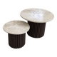 Round nesting coffee table in travertine and dark fluted wood.