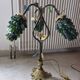 Bronze table lamp and Murano glass grape clusters.