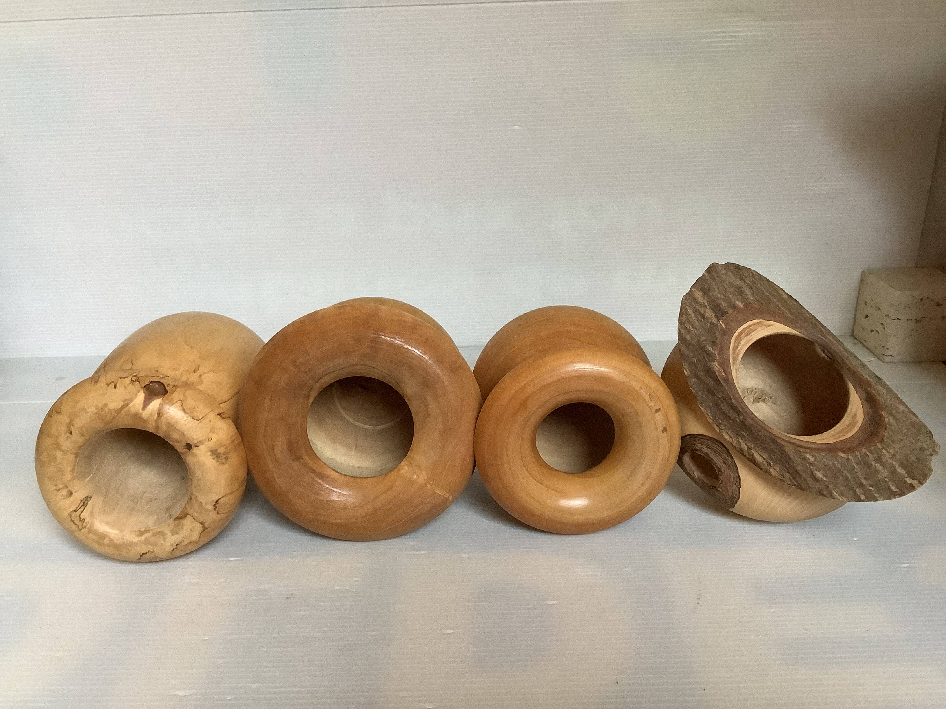 Four solid turned wooden vases