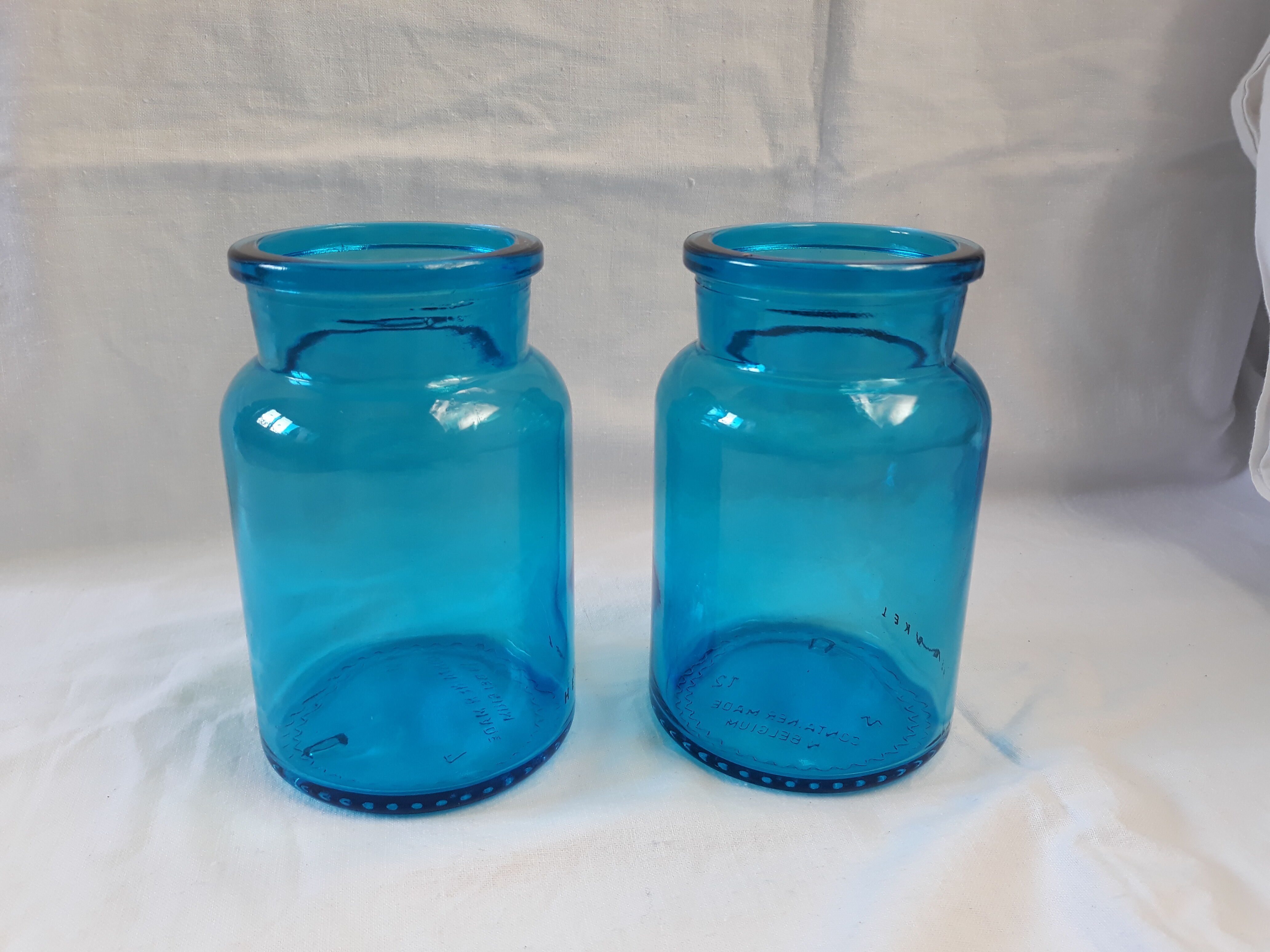 pair of apothecary vials in blue glass jar
