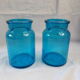 pair of apothecary vials in blue glass jar