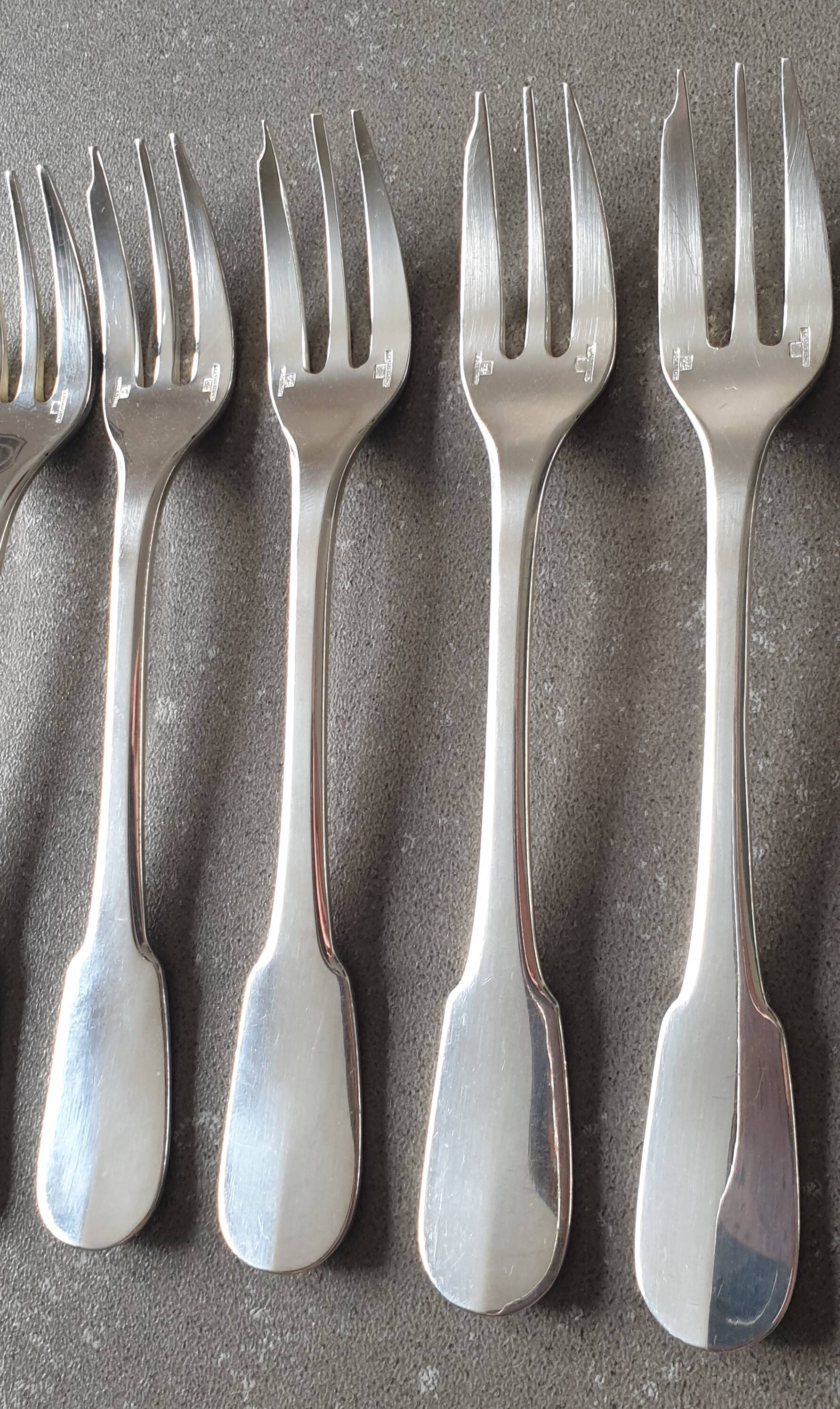 Set of 12 dessert forks and a cake server.