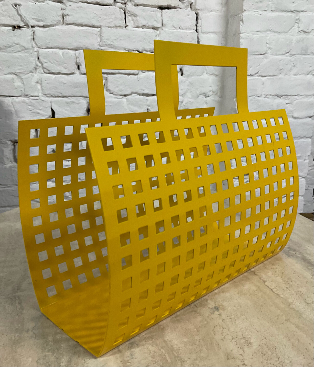 Vintage magazine rack in yellow metal
