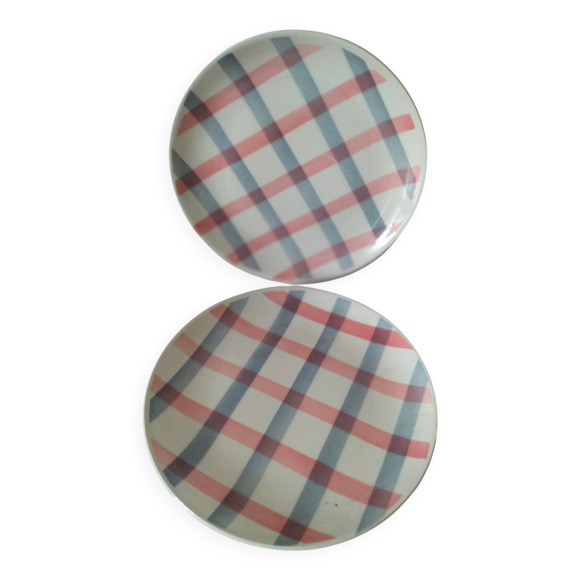 Two dessert plates Moulin des Loups with a pink and grey tablecloth design.