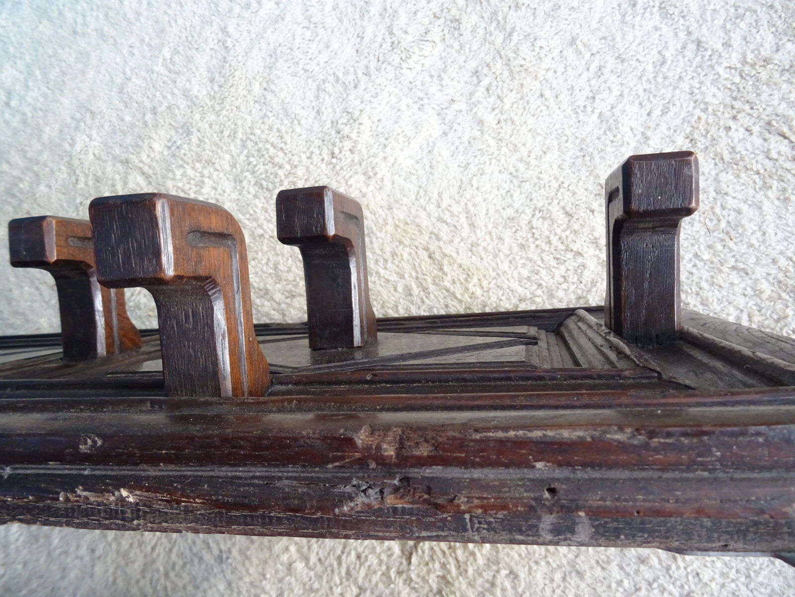 Wall-mounted coat rack in solid oak with 9 hooks.