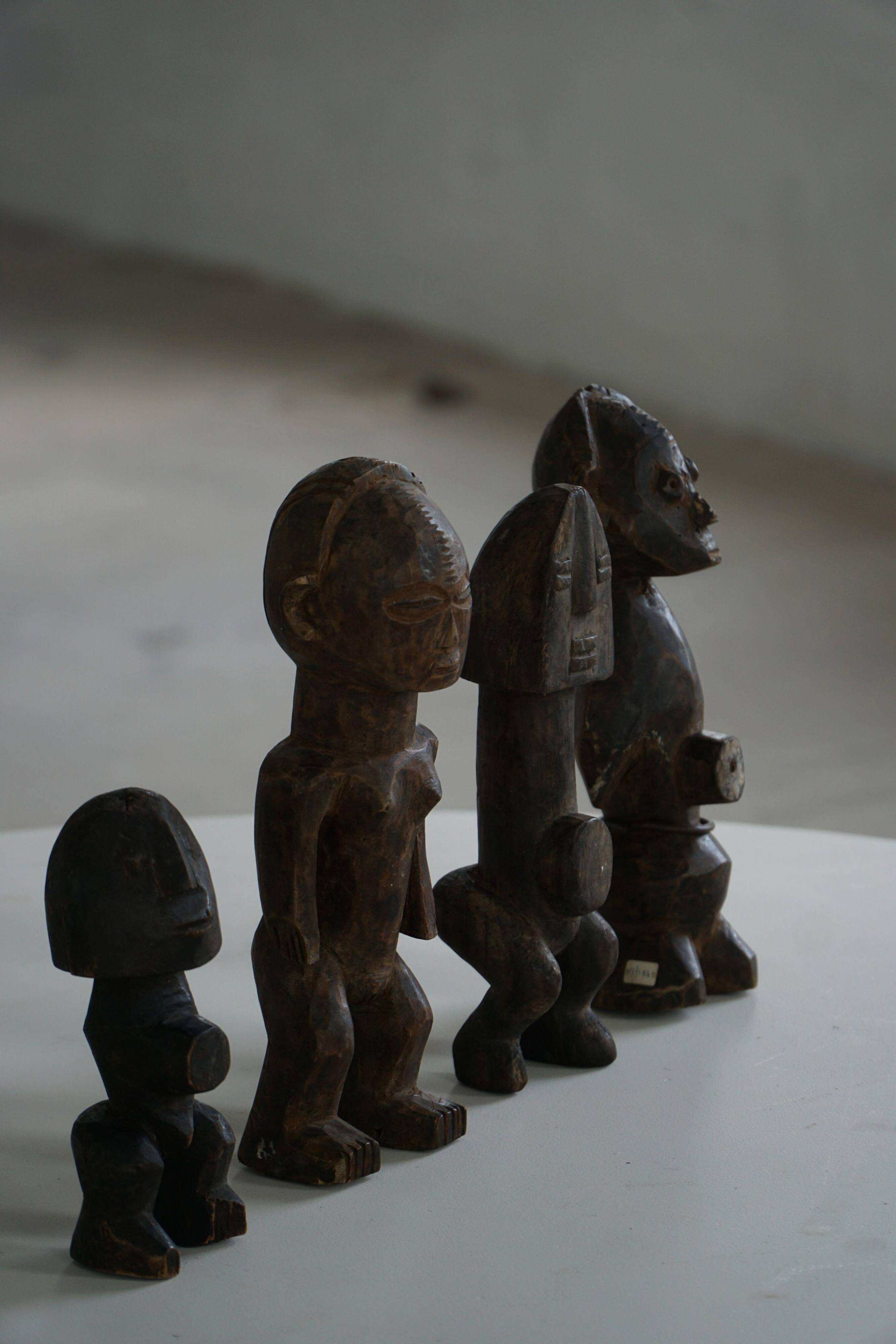 Set of 4 decorative handcrafted African wooden sculptures, mid-century.