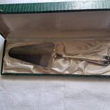 Silver metal cake peeler.