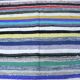 Vintage traditional nomadic kilim ethnic rug with multicoloured stripes.