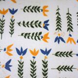 Vintage laminated wooden trivet with yellow, green, and blue flowers