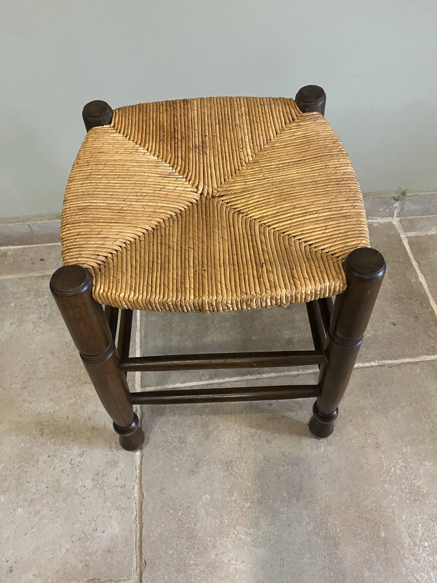 Wooden stool with a straw seat