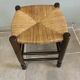 Wooden stool with a straw seat