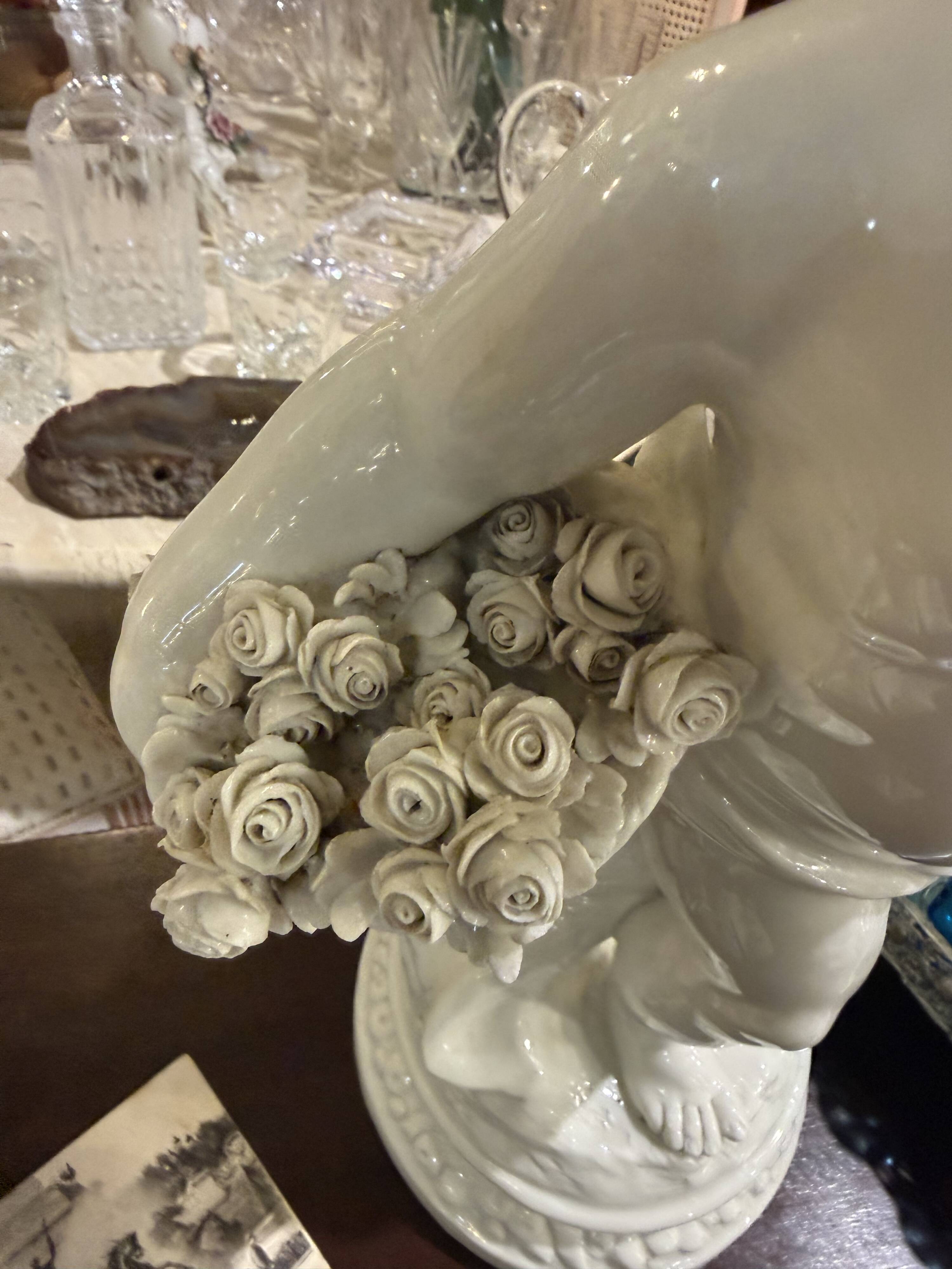 Child statue with flowers in porcelain, signed.