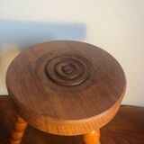 Round tripod stool in carved wood