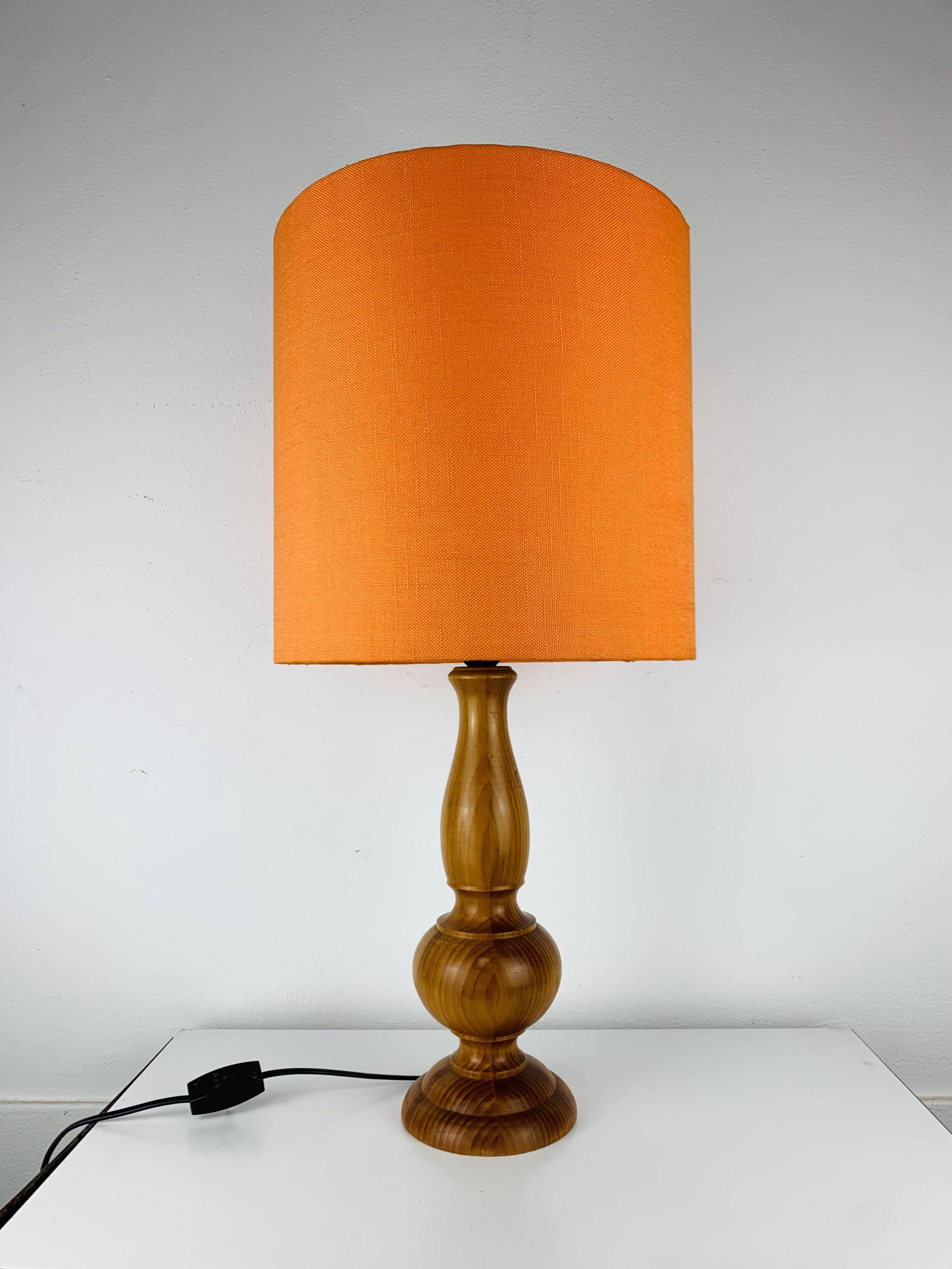 Turned wood lamp with orange shade, 1970s.