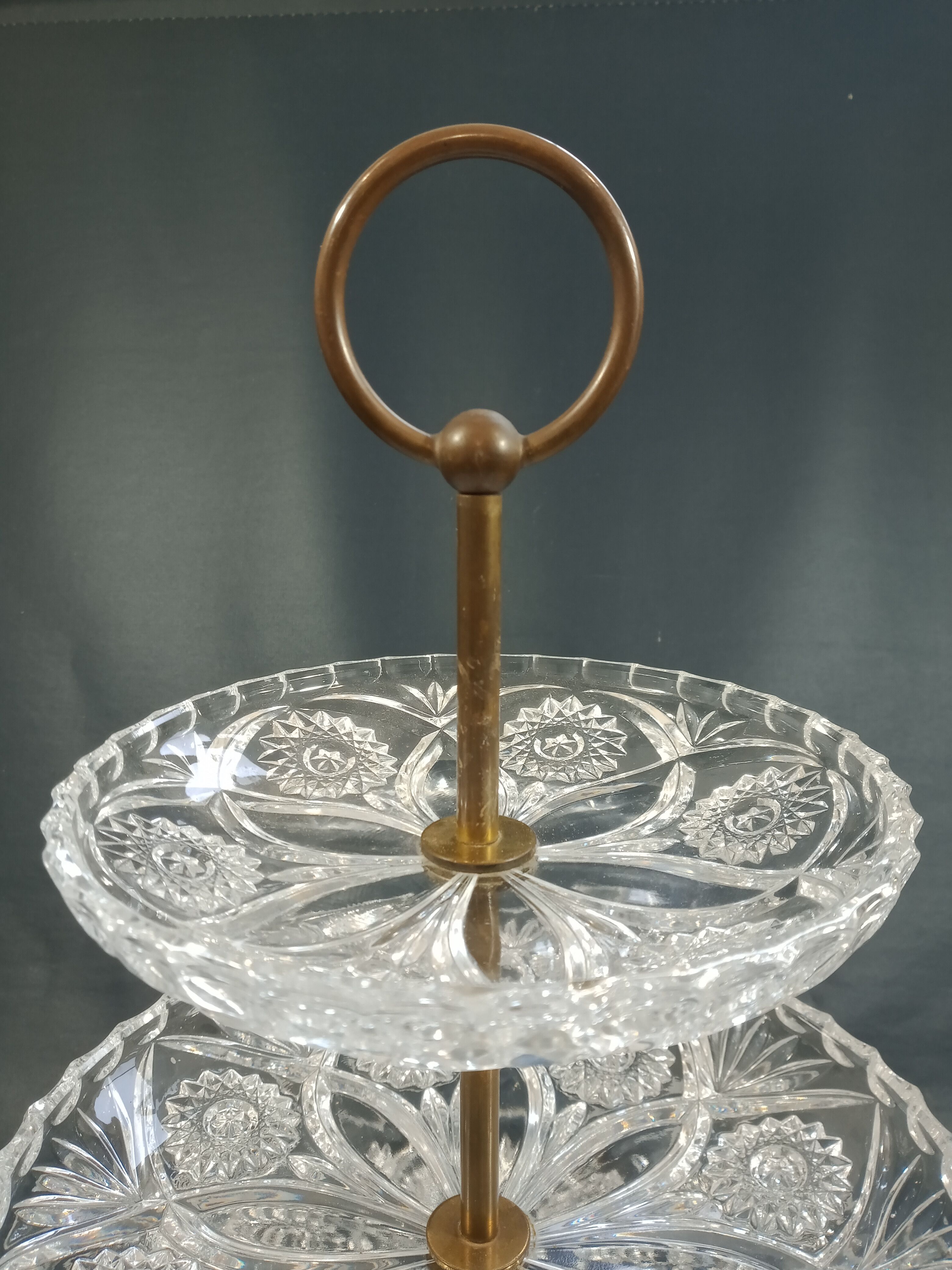 Three-storey display in chiseled glass and brass