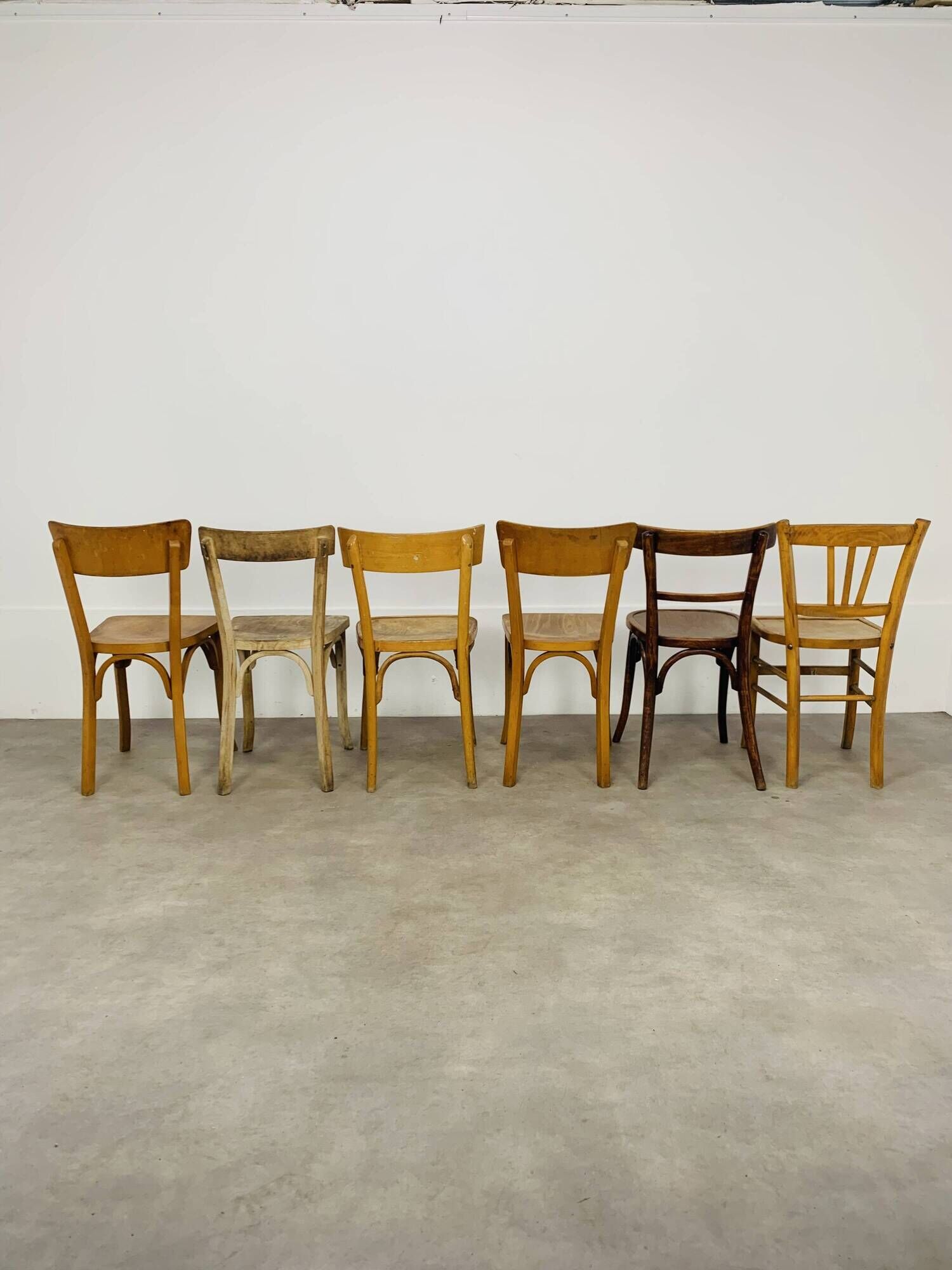 6 mismatched Baumann & Luterma bistro chairs, wood, 1960s