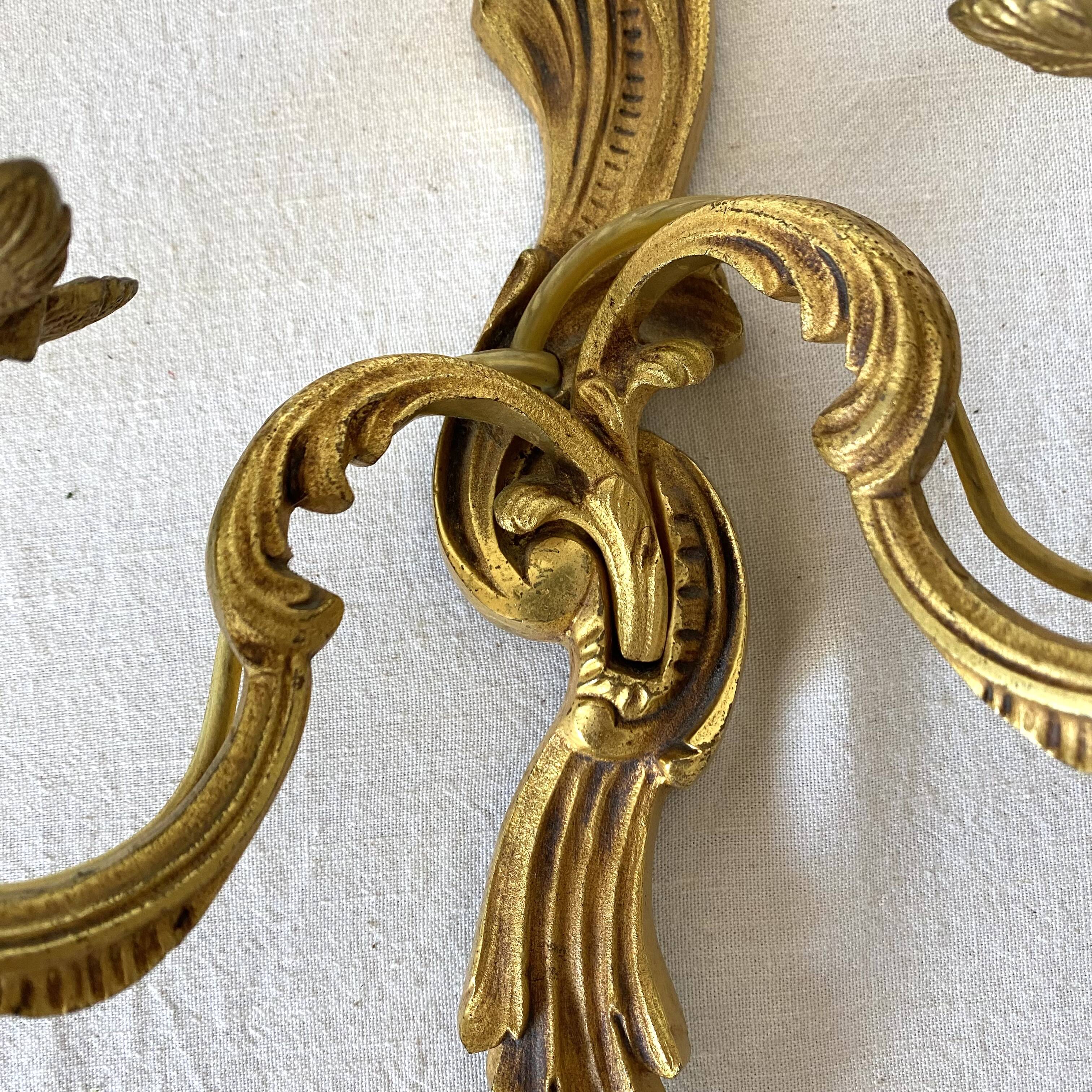 Pair of golden rococo-style wall lights
