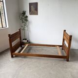 Brutalist style bed with chain and straw