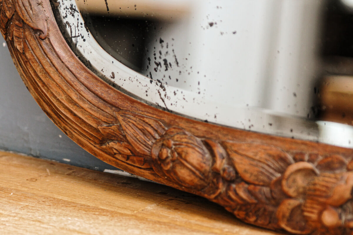 Beveled mirror in carved wood